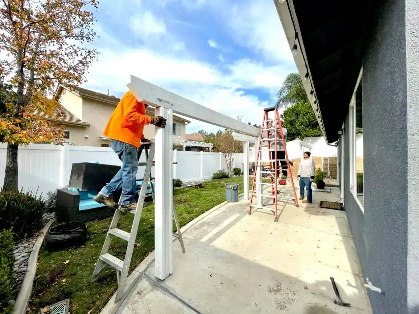 Workers taking down a patio cover